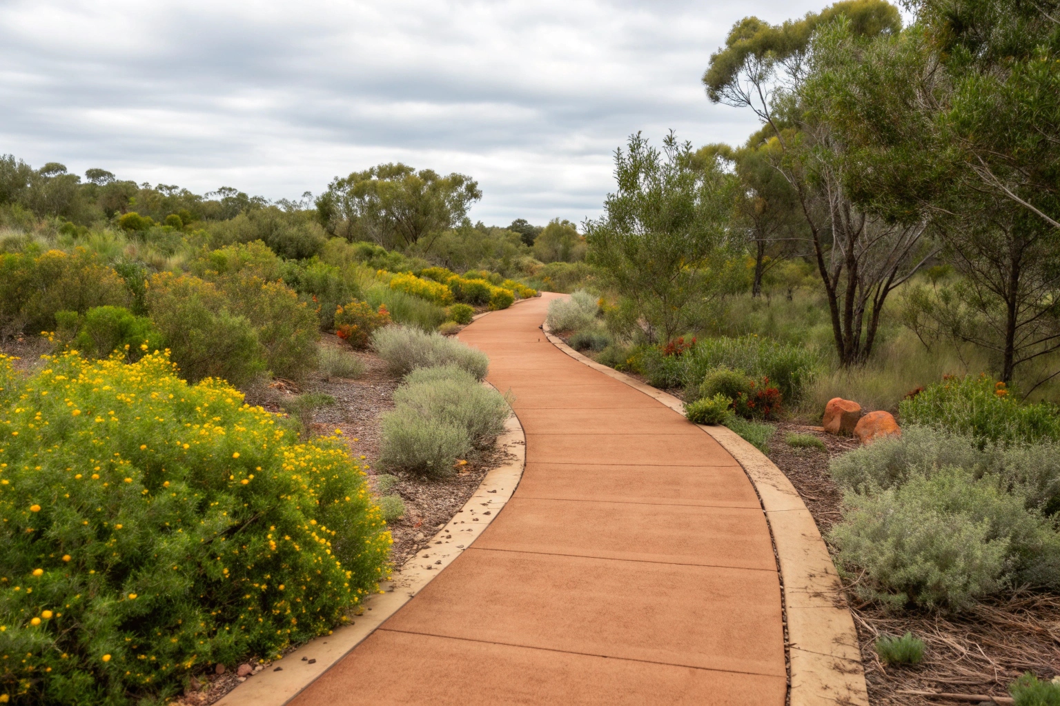 Earth-toned coloured concrete walkway complementing the natural Canberra landscape